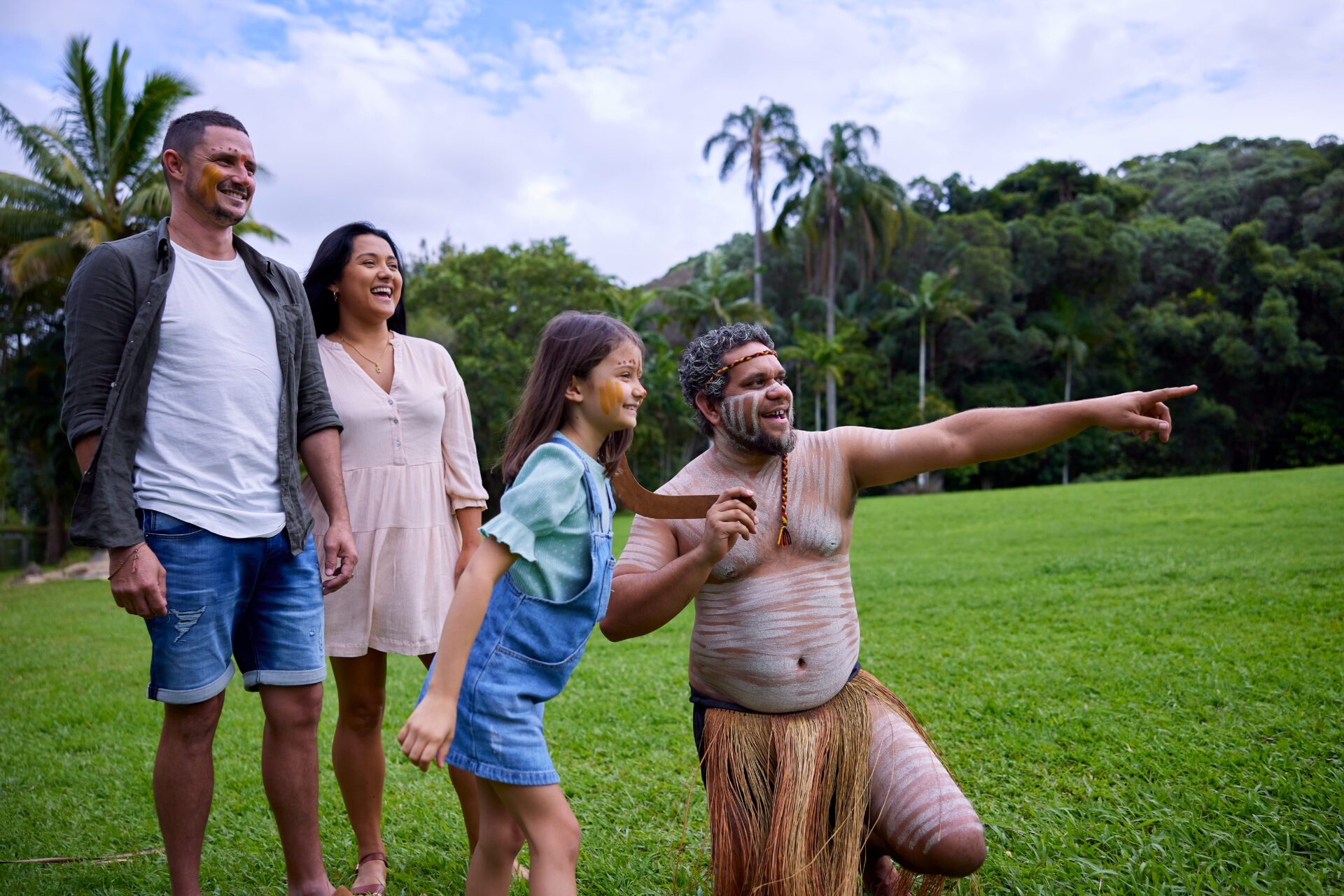Family being shown how to throw a boomerang at Rainforestation, part of a Tropic Wings day tour