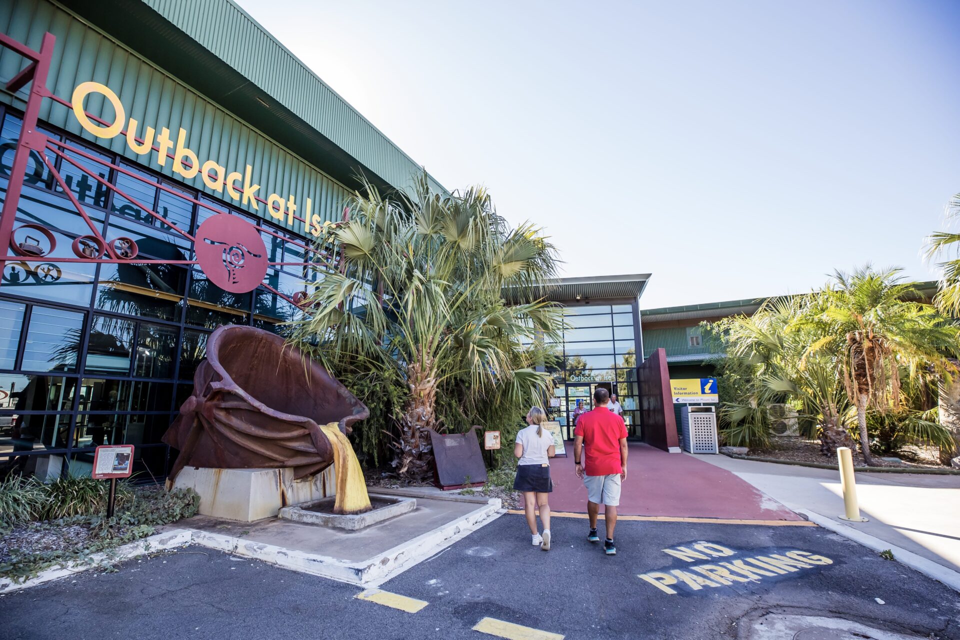 Couple walking in to Outback at Isa